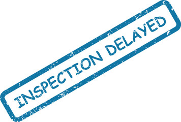 Prominent blue rubber stamp showing the words INSPECTION DELAYED on a crisp white backdrop