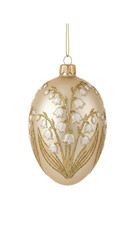 Matte champagne egg shaped Christmas ornament with white lily of the valley flowers and gold glitter isolated.