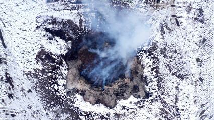 Burning manure pile at farm, air pollution and contamination, drone pov