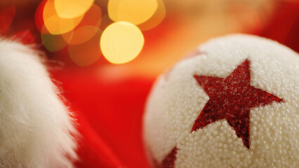 White Christmas ornament with red star and Santa Hat with bokeh lights