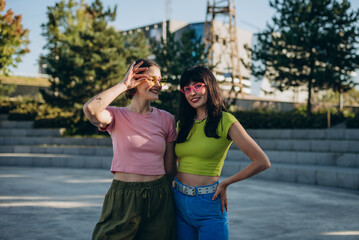 Portrait of women friends smile and share gentle hug together on sport ground