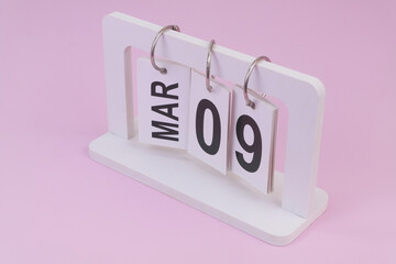 March 9 on calendar on pink background