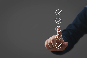 Finger selecting check mark icons on virtual checklist. Concept of task completion, approval process, validation, quality control, workflow management, productivity, and business efficiency.