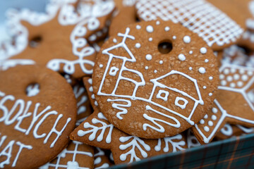 Decorative Christmas gingerbread cookies featuring a church and house design, arranged in a festive presentation. Ideal for holiday themes, baking promotions, and seasonal marketing.