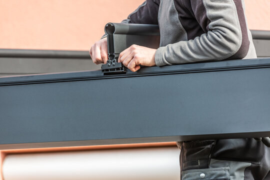Workers install patio roofing with steel and glass