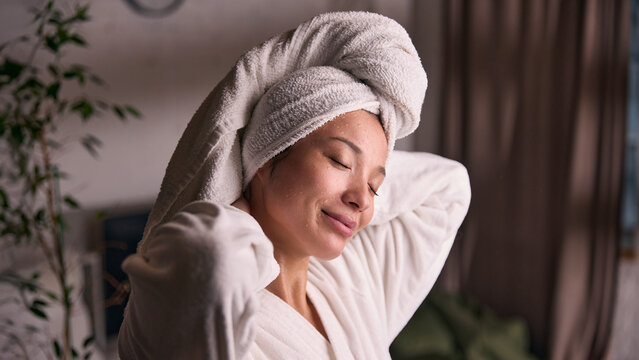 Woman in bathrobe relaxing at home after skincare routine. Concept of home spa lifestyle, beauty selfcare, comfort living, wellness balance and relaxation content.