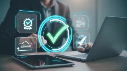 Person interacting with laptop and tablet displaying verification icons on a wooden desk