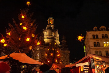 Christmas in Dresden, Saxony, Germany. View of the Frauenkirche and a Christmas tree decorated with Christmas stars.