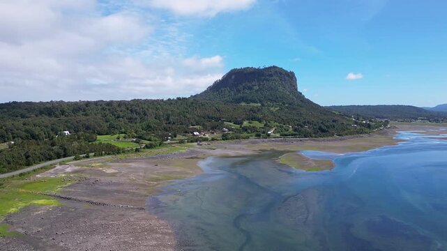 Hualaihue, Chile: Aerial drone footage of Hualaihue, rural area in Lake district of Chile with mountain in the background near Hornopiren. Taken with forward motion
