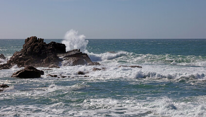 Waves breaking over granite rocks, Jersey, Channel Islands
