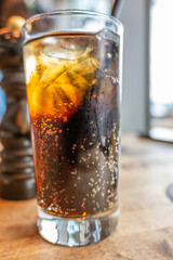 Glass of Ice cold cola drink with straw