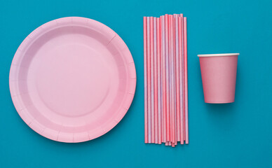 Set of disposable tableware for birthday party on blue background. Top view