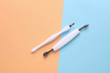 Set of tools for nail care, manicure and pedicure on pink blue background