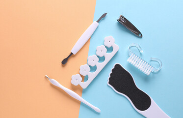 Set of tools for nail care, manicure and pedicure on pink blue background