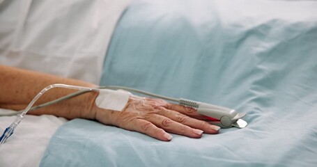 Hand, person and pulse oximeter on hospital bed, healthcare and measure blood levels. Closeup, senior patient and rest with medical machine, track oxygen and critical care from operation or recovery