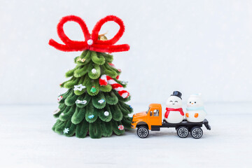 Snowman friends on orange truck with Christmas tree on white background, Christmas card background idea