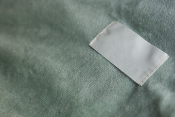 White tag on Mint green color fleece cloth close up © splitov27