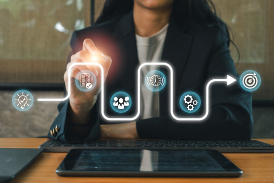 Businesswoman using digital interface for strategic planning, highlighting growth and development concepts. - Powered by Adobe