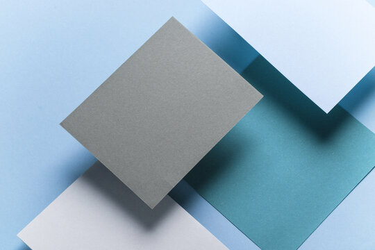 Set of colored floating blank card sheets with shadow on blue background. Minimalism business brand template, creative layout - Powered by Adobe