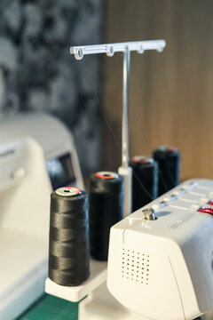 Stitching on sewing machine, overlocking. Stitch and overlock. Sewing and stitching at home, tailoring clothes at home.