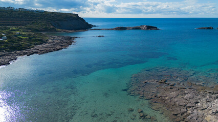Fototapeta premium Top aerial view of rocky coast and turquoise Mediterranean sea