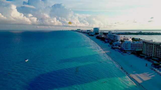 Aerial View of Cancun Beach with Parasailing and Turquoise Waters