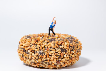 Fitness Woman Standing on Giant Donut Concept