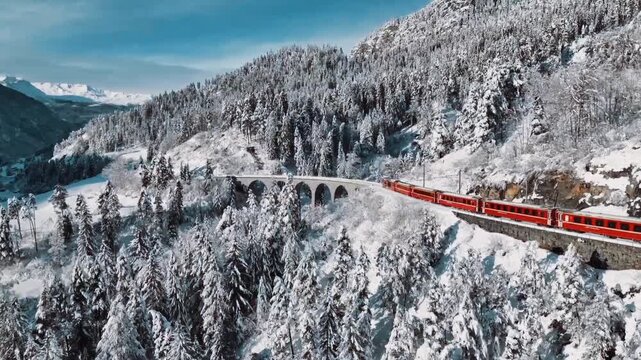 Aerial view of train passing through famous mountain in filisur landwasser viaduct world heritage with train express in swiss alps snow winter scenery