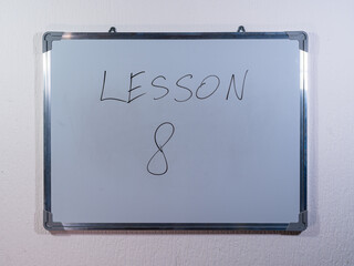 Whiteboard showing LESSON message representing knowledge transfer, training and skill development