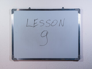 Whiteboard showing LESSON concept on minimal background representing education stages and learning journey