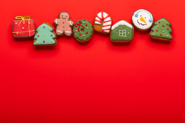 Christmas gingerbread cookies top border on red background
