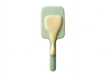 Green spatula dripping liquid batter during baking process