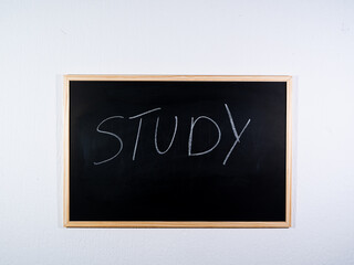 Chalkboard showing STUDY concept on black background representing learning process, education and knowledge acquisition