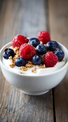 Delicious bowl of yogurt topped with fresh blueberries and raspberries, ideal for a healthy breakfast or dessert, set against a rustic wooden background for aesthetic appeal.