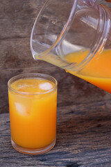 Soft drinks orange juice and iced in glass