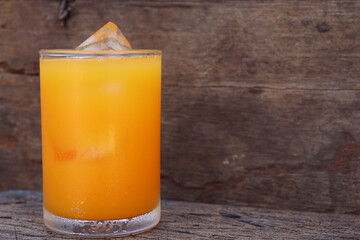 Soft drinks orange juice and iced in glass