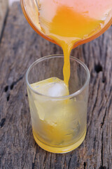 Soft drinks orange juice and iced in glass