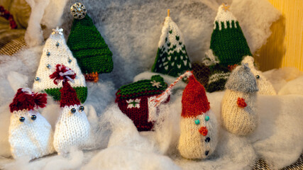 Christmas decorations from various knitted items, gnomes, snowmen, trees and houses, beautiful card, festive mood