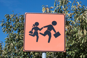 Road traffic sign warning of school children crossing road