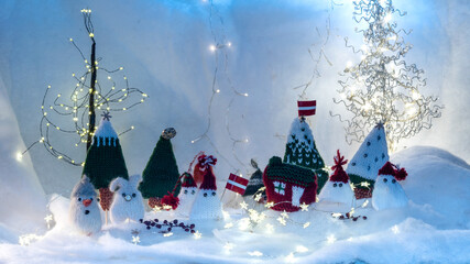 Christmas decorations from various knitted items, gnomes, snowmen, trees and houses, beautiful card, festive mood