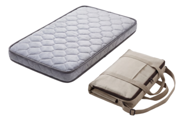 Portable travel crib mattress with carrying case, ideal for trips and overnight visits.