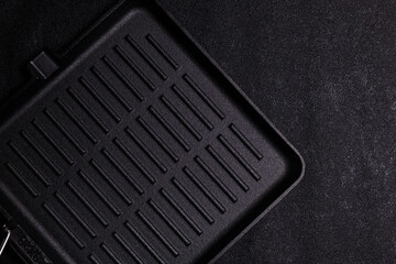 Grill pan placed on a black surface ready for cooking food such as vegetables and meats in a home...