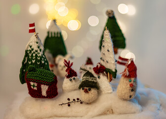 Christmas decorations from various knitted items, gnomes, snowmen, trees and houses, beautiful card, festive mood