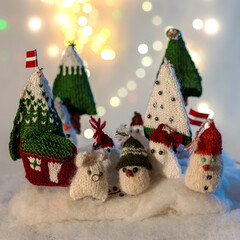 Christmas decorations from various knitted items, gnomes, snowmen, trees and houses, beautiful card, festive mood