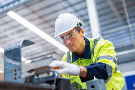 Engineer paper cardbox container factory in professional uniform check and analyse paper industrial machine. Male factory worker testing program in high teachnology paper production line. worker. 