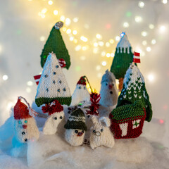 Christmas decorations from various knitted items, gnomes, snowmen, trees and houses, beautiful card, festive mood
