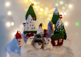 Christmas decorations from various knitted items, gnomes, snowmen, trees and houses, beautiful card, festive mood