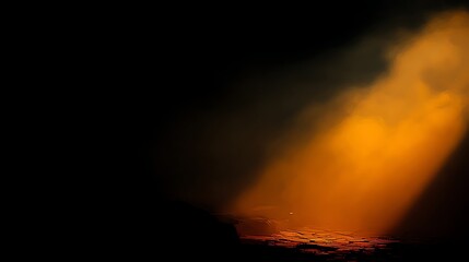Dramatic illuminated scene with a beam of orange light shining on a dark surface and cloud