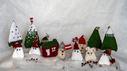 Christmas decorations from various knitted items, gnomes, snowmen, trees and houses, beautiful card, festive mood