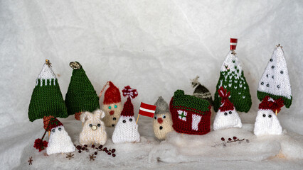 Christmas decorations from various knitted items, gnomes, snowmen, trees and houses, beautiful card, festive mood
